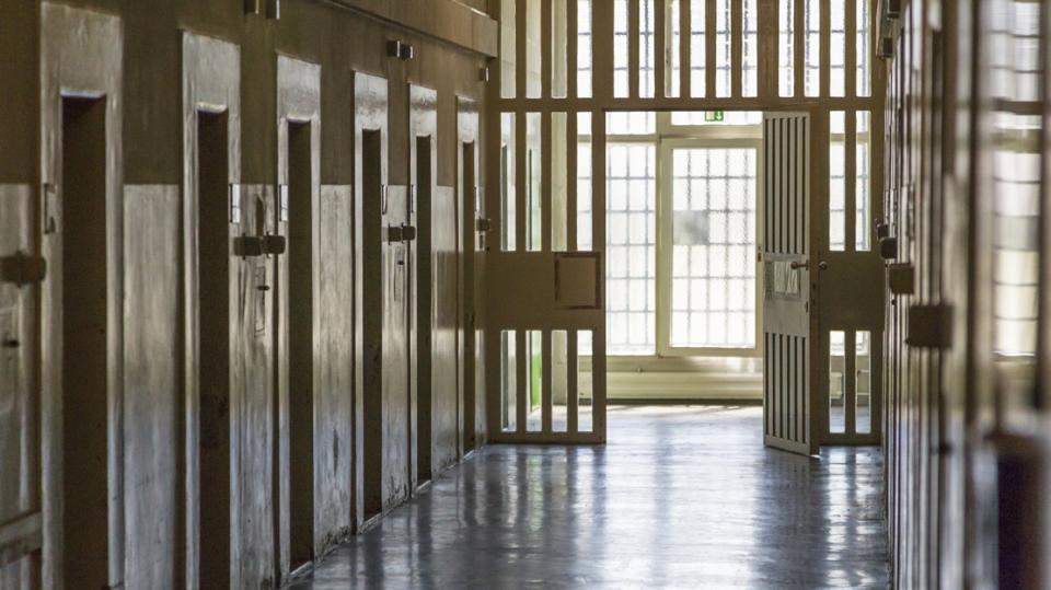 Durchgang im Gefängnis mit Zellentüren links und rechts